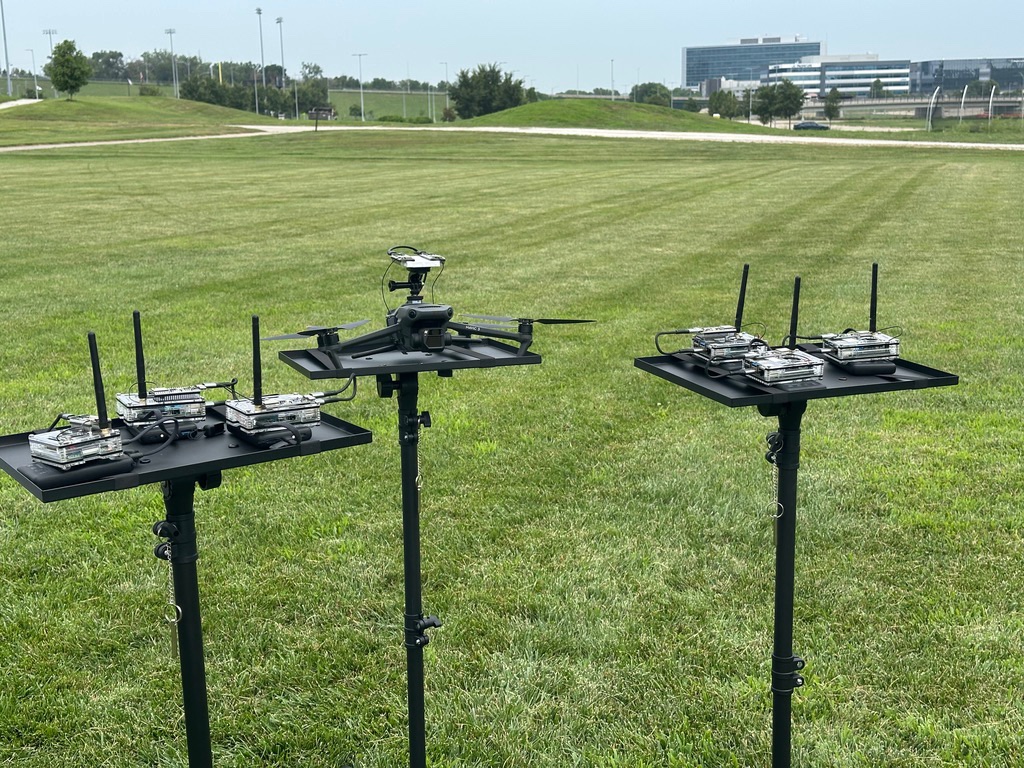 Distributed Raspberry Pi wireless sensing nodes and a drone mounted on tripods outdoors